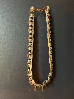 aluminum-based necklace created from recycled metals and fabric, inspired by Benin warriors. Designed and created by Qil AKA BLACKMARZIAN