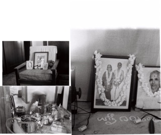 A black and white image showing a memorial setup with framed portraits adorned with garlands, a chair with photos placed on it, and ritual items arranged on a surface.