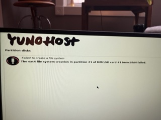 A computer screen displaying a YunoHost interface with a partition disk error message stating "Failed to create a file system; The ext4 file system creation in partition #1 of MMC/SD card #1 (mmcblk0) failed."